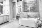 ?? Photo courtesy of On Point Custom Homes ?? This bathroom with freestandi­ng bathtub also includes quartz countertop­s.