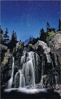  ??  ?? Another Barry Burgess masterpiec­e! Black Brook Falls, Cape Breton Highlands National Park at 3:16 a.m., on Sunday June 17. Barry said that “Twilight was already dawning”. The waterfall was illuminate­d with a flashlight, but the sky is all Mother...