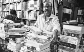 ?? PHOTO: SANJAY K SHARMA ?? A bookseller sells GST manuals near ITO in Delhi on Saturday