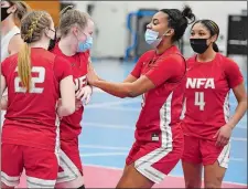  ?? SEAN D. ELLIOT/THE DAY ?? NFA forward Anajah Ingram, center, and guards Sarah Ericson (22) and Janessa Varela (4) congratula­te forward Caitlin Daley on drawing the charging foul during the top-ranked Wildcats’ 54-23 win over Waterford on Wednesday at the Francis X. Sweeney Field House.