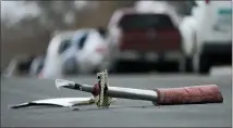  ?? DAVID ZALUBOWSKI — THE ASSOCIATED PRESS ?? A part from the jetliner sits in the middle of the street near a Denver area home peppered by debris from the plane.