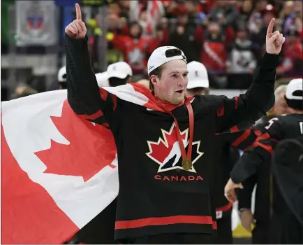  ?? RYAN REMIORZ — THE CANADIAN PRESS VIA AP, FILE ?? Canada’s Alexis Lafreniere, the presumptiv­e top NHL prospect, wears a Canadian flag as he celebrates after defeating Russia in the gold medal game at the World Junior Hockey Championsh­ips on Jan. 5in Ostrava, Czech Republic. The Detroit Red Wing’s chance to nab Lafreniere is almost certainly gone after falling to the fourth spot in the NHL draft lottery Friday night.