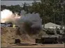  ?? LEO CORREA / AP ?? An Israeli mobile artillery unit fires a shell Monday from southern Israel toward the Gaza Strip in a position near the Israel-Gaza border.