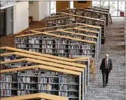  ?? LISA POWELL / STAFF ?? Tim Kambitsch, the executive director of the Dayton Metro Library (pictured), calls the new downtown facility a “rebirth of a building.” The new library has been under constructi­on for two years and has been in the same location since 1888.