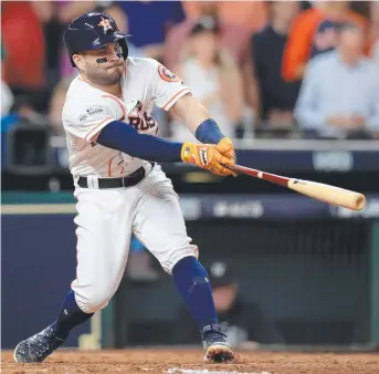  ??  ?? Jose Altuve hits a home run for the Houston Astros against the New York Yankees yesterday