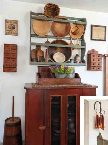  ??  ?? Above: On a kitchen wall, dough bowls, wooden utensils and other primitives are contained in a distressed, sage-colored plate rack— another one of Sheila’s handcrafte­d pieces. Vintage spice boxes and wall art frame the rack and the antique pie safe below, which hosts another spice cabinet tucked into a box on top.