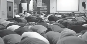  ?? KYLE ROBERTSON/COLUMBUS DISPATCH ?? Imam Farhan Ali leads Masjid Abu Hurairah members during Friday prayer at the mosque in Columbus on April 1.