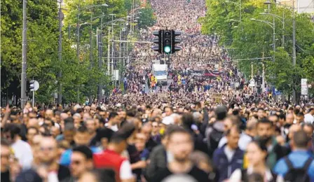  ?? DARKO VOJINOVIC AP ?? People march during a protest against violence in Belgrade, Serbia, on Friday, the third and largest such event over the government’s handling of a crisis after two mass shootings in the Balkan country earlier this month.