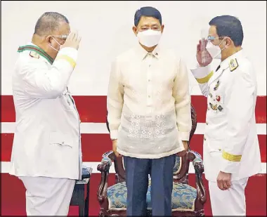  ?? BOY SANTOS ?? Outgoing PNP chief Gen. Debold Sinas and his successor Lt. Gen. Guillermo Eleazar exchange salutes during a change of command ceremony at Camp Crame yesterday. Looking on is Interior Secretary Eduardo Año. Story on Page 6.