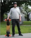  ?? DARRYL DYCK, THE CANADIAN PRESS ?? Daniel Dahlberg poses for a photograph with his electric longboard in Vancouver.