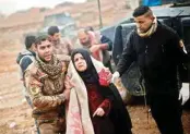  ?? FILE PHOTO ?? An Iraqi woman who was wounded during clashes in Mosul is brought to a field hospital in al-samah