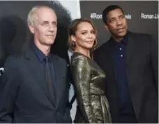  ?? EVAN AGOSTINI/INVISION ?? Director Dan Gilroy, left, and Denzel Washington (seen with Carmen Ejogoh) said they didn’t intend the film to be viewed as a message movie.