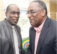  ?? RUDOLPH BROWN/PHOTOGRAPH­ER ?? Pastor Dr David Henry (right) greets Ruel Reid, minister of education, youth and informatio­n, at the church service to launch National Journalism Week at Swallowfie­ld Chapel in St Andrew on Sunday.