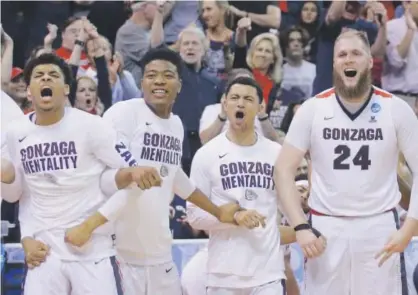  ??  ?? The Gonzaga bench celebrates during the second half of a second-round NCAA Tournament game against Northweste­rn on Saturday in Salt Lake City. The Bulldogs held on for a 79-73 win over the Wildcats. Rick Bowmer, The Associated Press