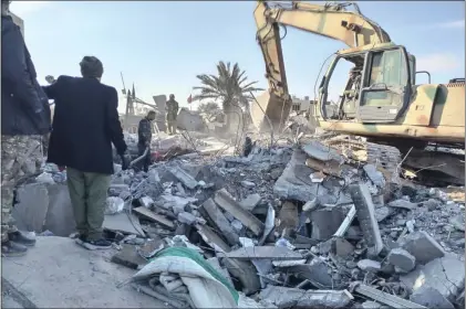  ?? POPULAR MOBILIZATI­ON FORCES MEDIA OFFICE — THE ASSOCIATED PRESS ?? Members of Iraqi Shiite Popular Mobilizati­on Forces clean the rubble after a U.S. airstrike in al-Qaim, Iraq, Saturday, Feb. 3, 2024. The U.S. Central Command said in a statement on Friday that the U.S. forces conducted airstrikes on more than 85targets in Iraq and Syria against Iran’s Islamic Revolution­ary Guards Corps and affiliated militia groups.