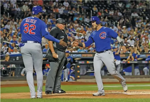  ?? JIM MCISAAC/GETTY IMAGES ?? Yan Gomes and Franmil Reyes celebrate after they both scored in the first inning against the Mets at Citi Field on Wednesday night.