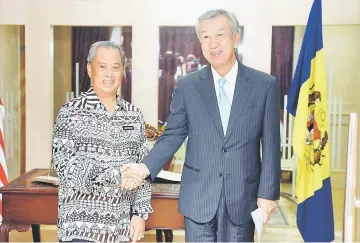  ??  ?? Muhyiddin (left) shakes hands with Miyagawa during the courtesy call. — Bernama photo