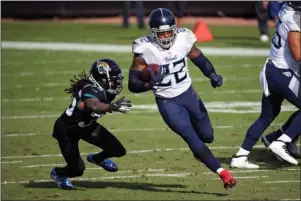  ?? CARRYING THE LOAD: The Associated Press ?? Tennessee Titans running back Derrick Henry (22) goes past Jacksonvil­le Jaguars cornerback Sidney Jones for a 36-yard touchdown during the first half of Sunday’s game in Jacksonvil­le, Fla.