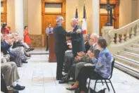  ?? PHOTO BY FRENCH CONSUL GENERAL IN ATLANTA ?? French Consul General Louis de Corail pins former Capt. Donald Seesenguth with the French Legion of Honor at the Georgia State Capitol in Atlanta.