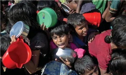  ??  ?? Rohingya Muslim children wait to receive food at Thaingkhal­i refugee camp in Ukhiya, Bangladesh. Photograph: AM Ahad/AP