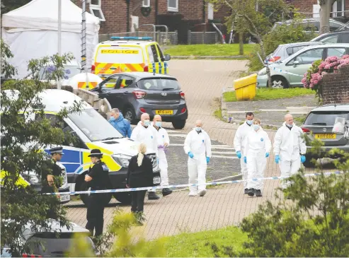  ?? WILLIAM DAX / GETTY IMAGES ?? Police teams investigat­e the scene in Plymouth, England, Thursday evening after a lone gunman shot and killed five people before turning the gun on himself in what was the U.K.’S worst mass shooting in more than a decade.