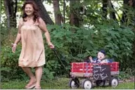  ?? William Bounthong ?? BOUNTHONG pulls her granddaugh­ter Ember in a wagon during her son William’s 2017 wedding in Illinois.