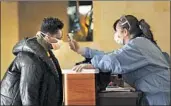  ?? MYUNG J. CHUN Los Angeles Times ?? A NURSE conducts a health check on a homeless resident at a converted West L.A. hotel on April 6.