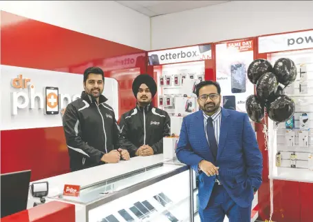  ?? MATT SMITH ?? Dr. Phone Fix co-managers Kapil Matta, left, and Gurkaran Singh, centre, stand with company owner Piyush Sawhney at their new Saskatoon store. Dr. Phone Fix recently opened two locations in the city and is expanding in Western Canada at a rate of one new store every three weeks.