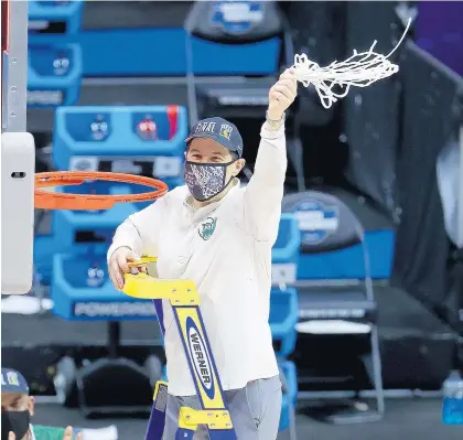  ?? ANDY LYONS/GETTY ?? Coach Scott Drew of the Baylor Bears cuts the net and celebrates after defeating the Arkansas Razorbacks in the Elite Eight round of the 2021 NCAA Men’s Basketball Tournament at Lucas Oil Stadium on March 29, 2021 in Indianapol­is.