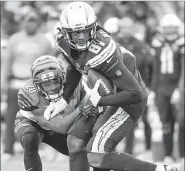  ?? Robert Gauthier Los Angeles Times ?? CHARGERS WIDE RECEIVER Mike Williams hauls down a pass in front of Bengals cornerback KeiVarae Russell during the second half of Sunday’s game.