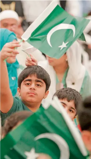  ??  ?? A young boy waves the national flag of Pakistan in patriotic spirit, during the community gathering held at the Pakistan Consulate in Dubai to celebrate the 70th Pakistan Independen­ce Day on Monday.