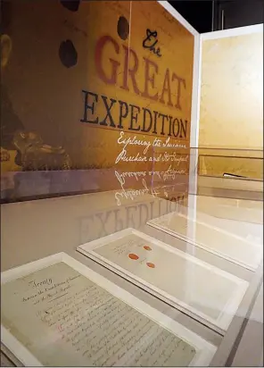  ??  ?? Historic documents from the 1803 Louisiana Purchase are carefully displayed under protective glass in the Clinton Presidenti­al Center. “The Great Exhibition: Exploring the Louisiana Purchase and Its Impact on Arkansas” will only be on display a short...