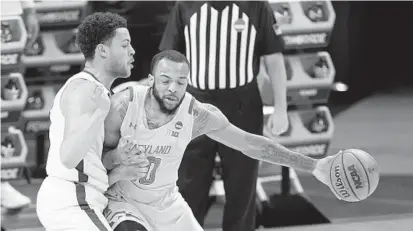  ?? MARK HUMPHREY/AP ?? Maryland’s Galin Smith, right, is defended by Alabama’s Alex Reese during the first half of a game in the second round of the NCAA tournament at Bankers Life Fieldhouse in Indianapol­is on Monday night.