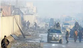  ?? Photo / AP ?? Afghan security forces gather at the site of an attack in Kabul as the US and the Taliban continue to work on a peace deal.