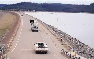  ?? MARCIO JOSE SANCHEZ/ASSOCIATED PRESS ?? Crew trucks make their way across Oroville Dam on Wednesday as the state drains the reservoir to prepare for several storms in the coming week.