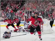  ?? BRUCE BENNETT/ GETTY IMAGES ?? New Jersey Devils’ rookie Adam Henrique ( right) celebrates after scoring the series- winning goal in overtime on Friday night.