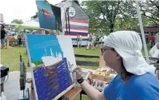  ?? DAVE JOHNSON/ TRIBUNE FILE PHOTO ?? Marion Forget paints the Federal Yukon on the grounds of Port Colborne Historical and Marine Museum in 2014.