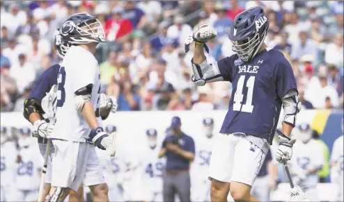  ?? Mitchell Leff / Getty Images ?? Matt Brandau (41) of Yale Bulldogs reacts in front of Tommy Wright (23) of Penn State Nittany Lions after scoring a goal in the first quarter of the NCAA Division I men’s lacrosse championsh­ip semifinals at Lincoln Financial Field on May 25 in Philadelph­ia.