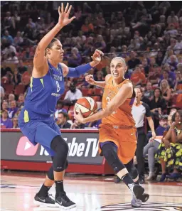  ??  ?? Mercury guard Diana Taurasi drives past Dallas Wings center Liz Cambage during a first-round WNBA playoff game on Tuesday.