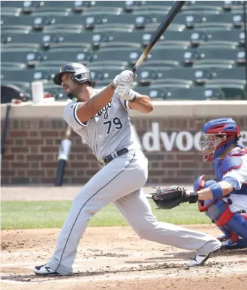  ?? NUCCIO DINUZZO/GETTY IMAGES ?? Jose Abreu follows the flight of his home run in the second inning Sunday at Wrigley Field.