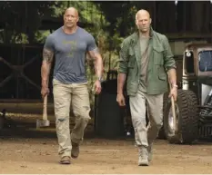  ?? FrAnk MASI/UnIVErSAL PIcTUrES VIA AP ?? This image released by Universal Pictures shows Dwayne Johnson (left) and Jason Statham in a scene from “Fast & Furious Presents: Hobbs & Shaw.”