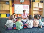  ?? PROVIDED TO CHINA DAILY ?? Toddlers sit around and listen to a foreign teacher at JD.com’s kindergart­en for staff children. free