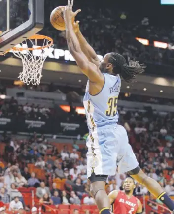  ?? Luis M. Alvarez, The Associated Press ?? Nuggets forward Kenneth Faried, dunkingMon­day night against the Heat in Miami, finished with game- high totals of 24 points and 11 rebounds. He made 11- of- 11 shots.