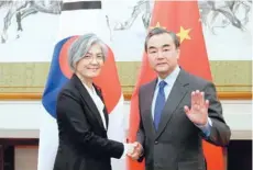  ?? — AFP ?? China’s Foreign Minister Wang Yi (R) with South Korea’s Foreign Minister Kang Kyung-wha at the Diaoyutai State Guesthouse in Beijing on Wednesday.