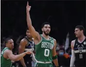  ?? CHARLES KRUPA — THE ASSOCIATED PRESS ?? Celtics forward Jayson Tatum (0) celebrates after a basket against the Bucks in the first half of Game 2of an Eastern Conference semifinal on Tuesday in Boston.