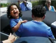  ?? THE ASSOCIATED PRESS ?? Ever Reyes Mejia, of Honduras, carries his son to a vehicle after being reunited and released by United States Immigratio­n and Customs Enforcemen­t in Grand Rapids, Mich., on Tuesday.