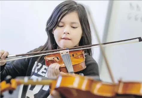  ?? PHOTOS: GORD WALDNER ?? St. Michael Community School students such as Dalyce O’Soup are learning to play the fiddle in the school’s music program after a gift of 25 new instrument­s from East Coast master fiddler Natalie MacMaster and her husband, Donnell Leahy.