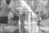  ?? CHRIS SWEDA/CHICAGO TRIBUNE ?? Anchal Khanna of Chicago touches her son Veer Roy as the 2-year-old considers the landscape of Millennium Park’s Crown Fountain on Tuesday.