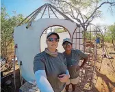  ??  ?? ABOVE: Trisha McDonald, left, and Erica Buckwalter pose for a selfie during their two weeks at the Painted Dog Research Center in Zimbabwe.