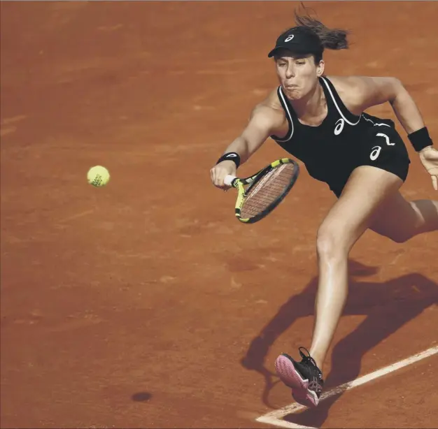  ??  ?? 0 Johanna Konta stretches to play a return on her way to 4-6, 3-6 defeat by world No 93 Yulia Putintseva in the first round of the French Open at Roland Garros yesterday.